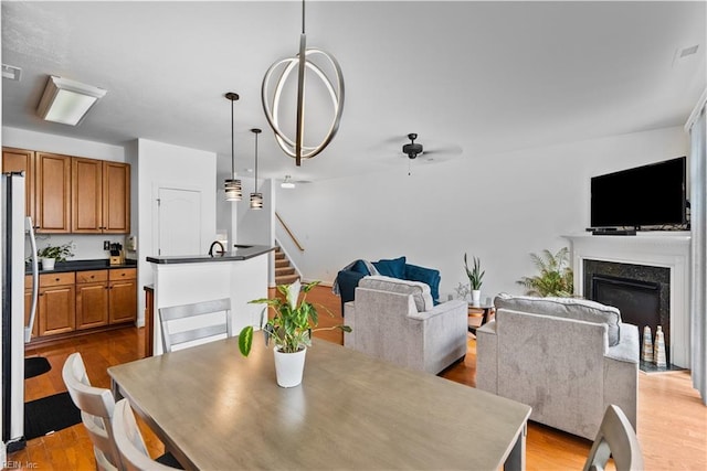 dining space featuring ceiling fan and light hardwood / wood-style floors