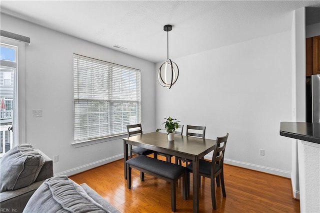 dining space featuring hardwood / wood-style flooring