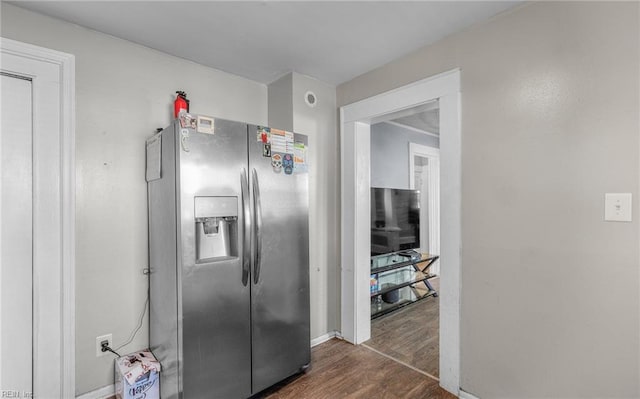 kitchen with stainless steel refrigerator with ice dispenser and dark wood-type flooring