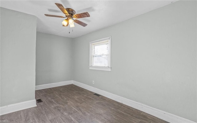 empty room with dark wood-type flooring and ceiling fan