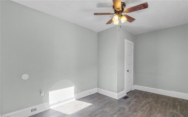 spare room with dark wood-type flooring and ceiling fan