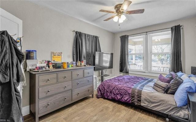 bedroom with light wood-type flooring and ceiling fan