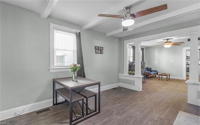 interior space featuring beamed ceiling, ceiling fan, dark hardwood / wood-style floors, and decorative columns