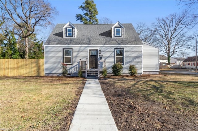 cape cod house featuring a front yard