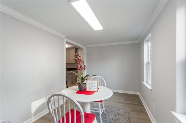 dining room featuring crown molding and hardwood / wood-style floors