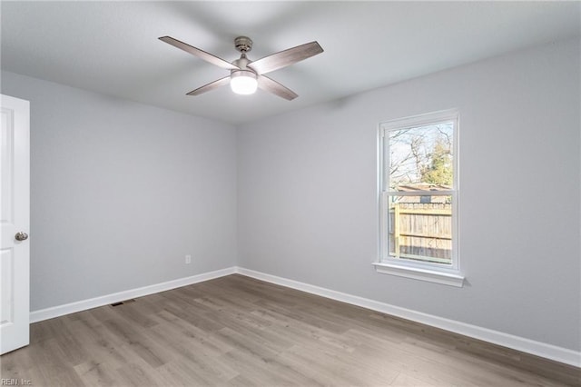 spare room featuring hardwood / wood-style flooring and ceiling fan