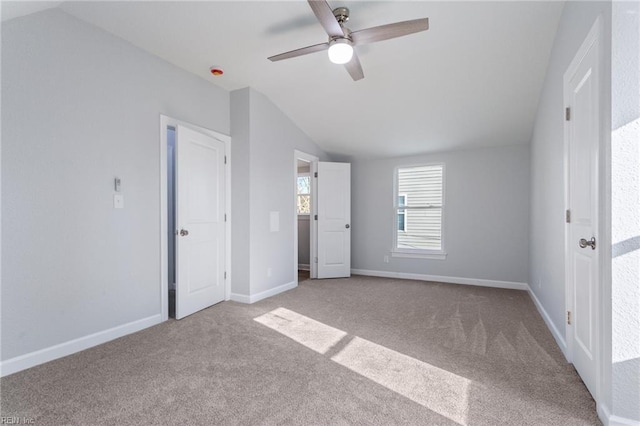 unfurnished bedroom with vaulted ceiling, light carpet, and ceiling fan