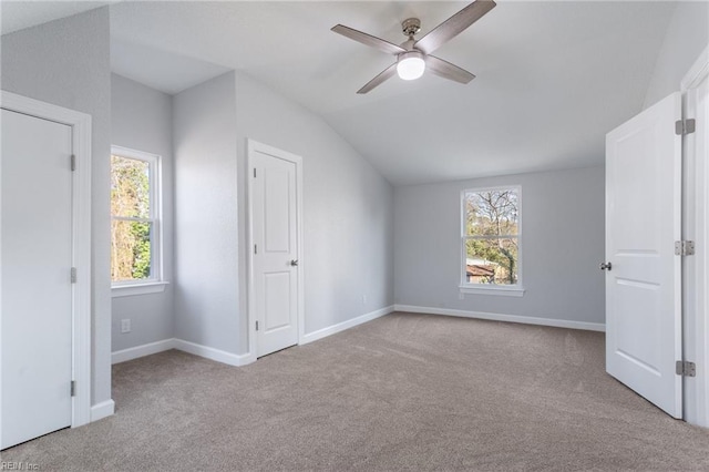 additional living space featuring ceiling fan, light colored carpet, and lofted ceiling