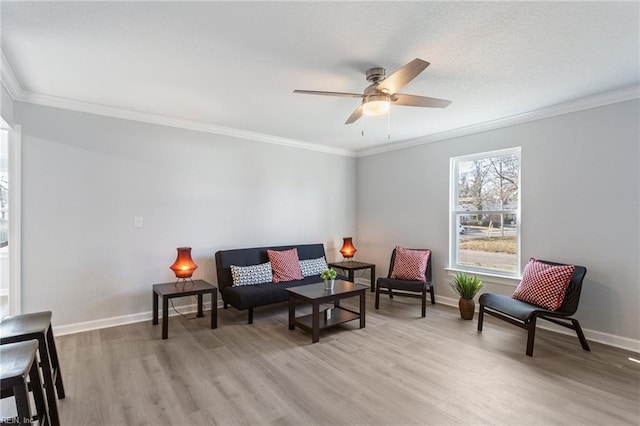 sitting room with ceiling fan, ornamental molding, and light hardwood / wood-style floors