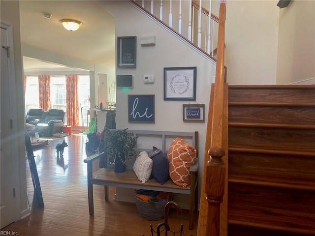 stairway with hardwood / wood-style floors