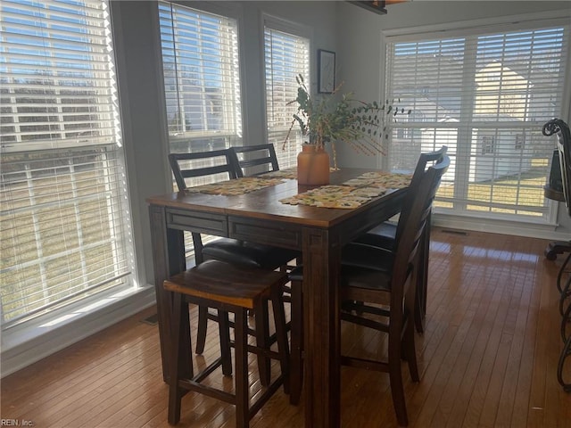 dining space featuring wood-type flooring