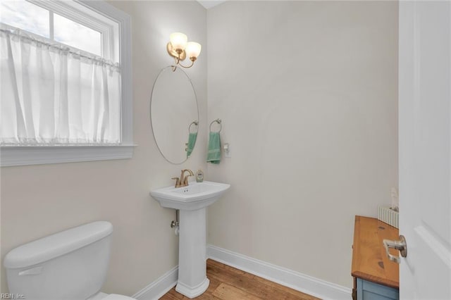 bathroom with sink, hardwood / wood-style floors, and toilet