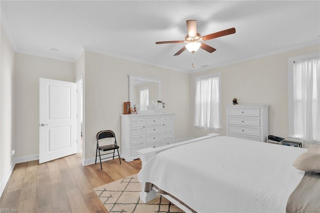 bedroom with crown molding, light wood-type flooring, and ceiling fan