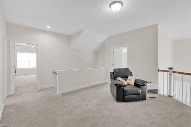 living area featuring lofted ceiling and light colored carpet