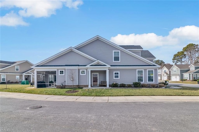 view of front of property with a front lawn and a sunroom