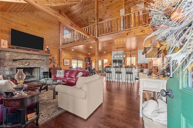 living room with wood ceiling, dark wood-type flooring, and wood walls