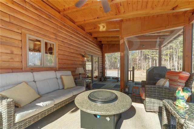 sunroom / solarium featuring wood ceiling, ceiling fan, and beam ceiling