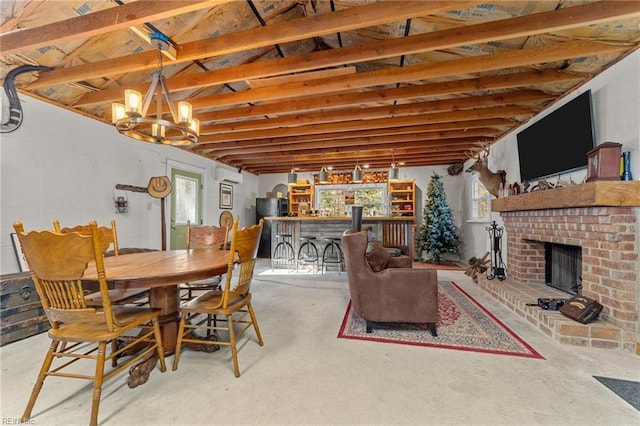 dining space with a notable chandelier, a fireplace, concrete flooring, and an AC wall unit