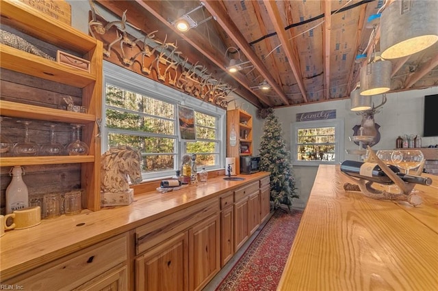 bar featuring a healthy amount of sunlight, sink, and butcher block countertops