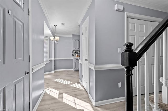 interior space with crown molding and a notable chandelier