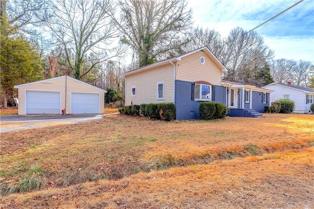 view of front of house featuring an outbuilding, a garage, and a front yard