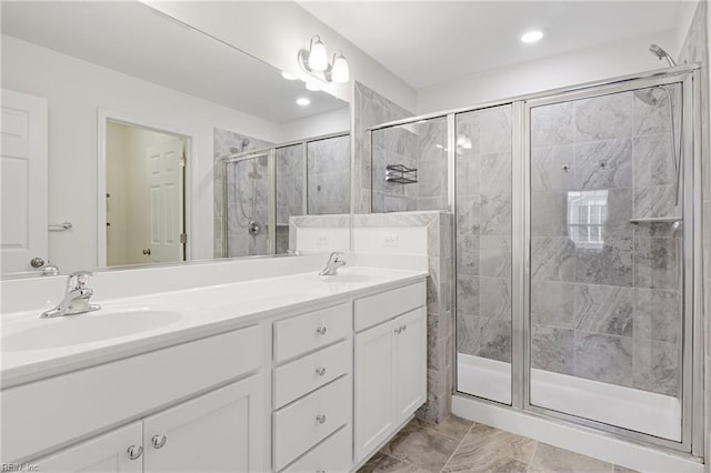 bathroom featuring vanity and a shower with shower door