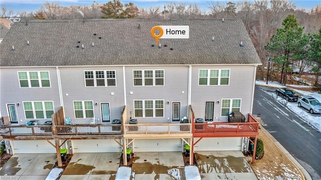 rear view of property featuring a garage