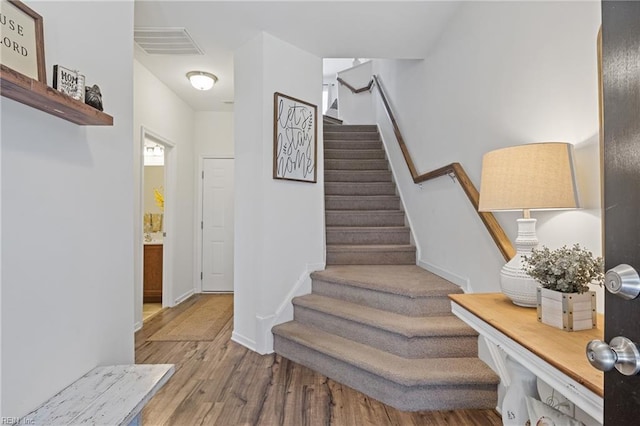 stairway featuring hardwood / wood-style flooring