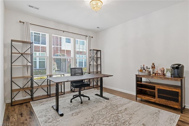 home office with dark wood-type flooring