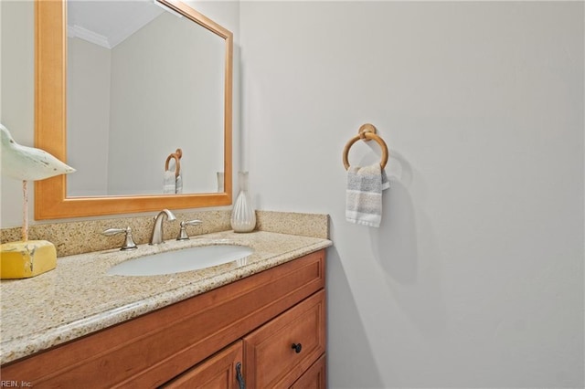 bathroom with crown molding and vanity