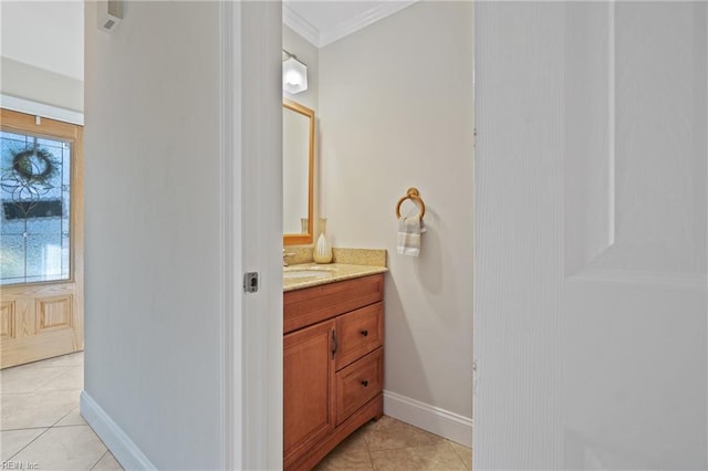 bathroom with ornamental molding, vanity, and tile patterned flooring