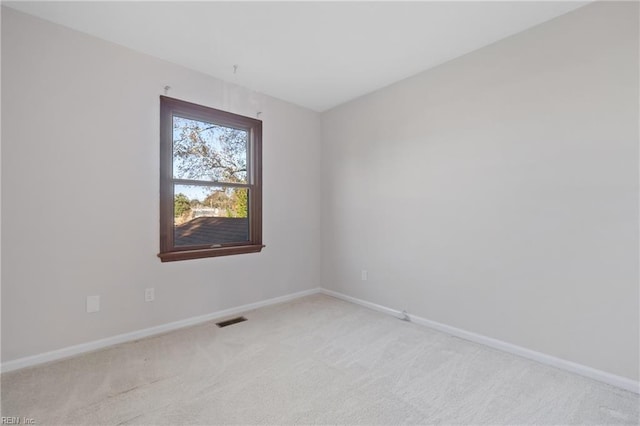 unfurnished room featuring light colored carpet