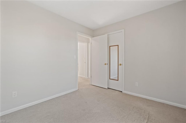 unfurnished room with light carpet