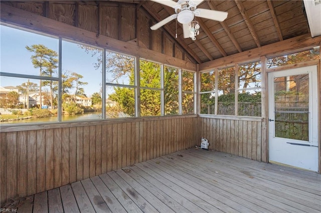 unfurnished sunroom featuring a water view, ceiling fan, wood ceiling, and lofted ceiling with beams