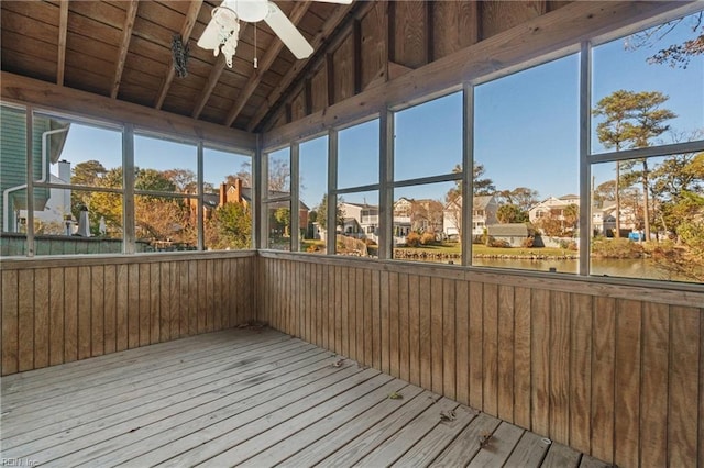 unfurnished sunroom with wood ceiling, a water view, lofted ceiling with beams, plenty of natural light, and ceiling fan