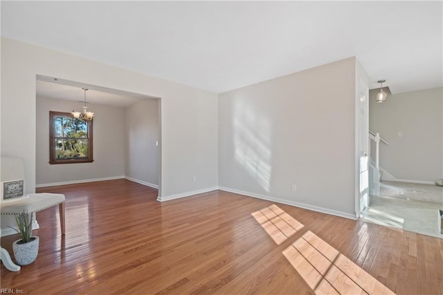 living room with wood-type flooring and an inviting chandelier