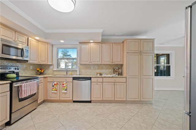 kitchen featuring stainless steel appliances, ornamental molding, sink, and light brown cabinets