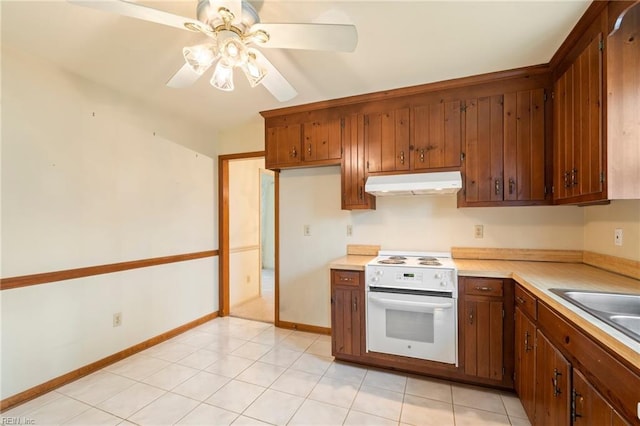 kitchen featuring sink, electric range, ceiling fan, and light tile patterned flooring