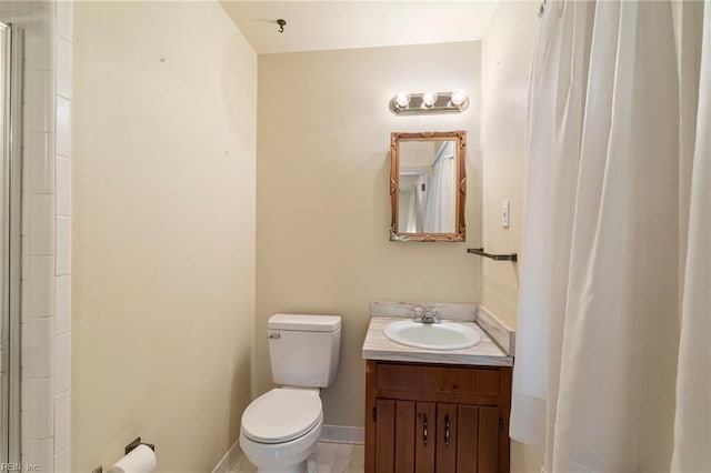 bathroom featuring vanity, toilet, and a shower