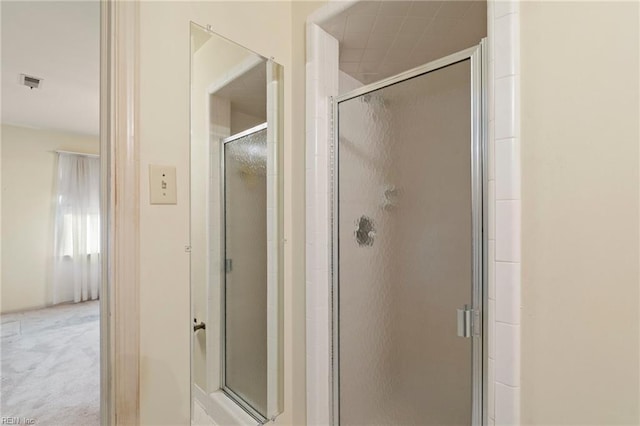 bathroom with a shower with shower door