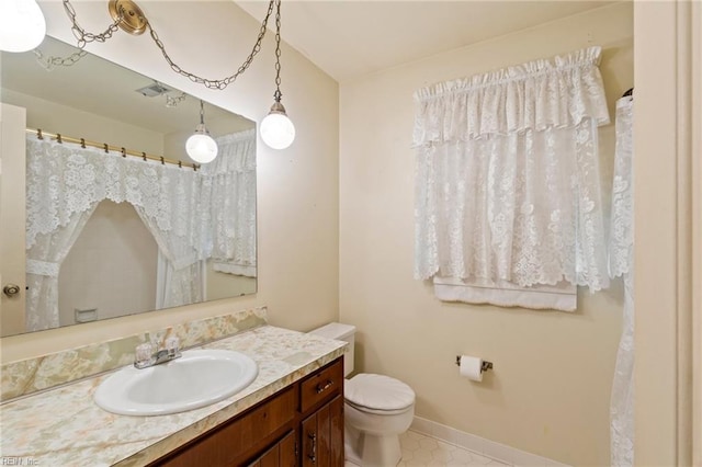 bathroom with vanity and toilet