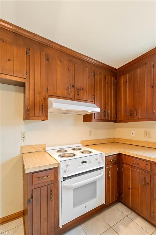 kitchen with light tile patterned floors and white electric range oven