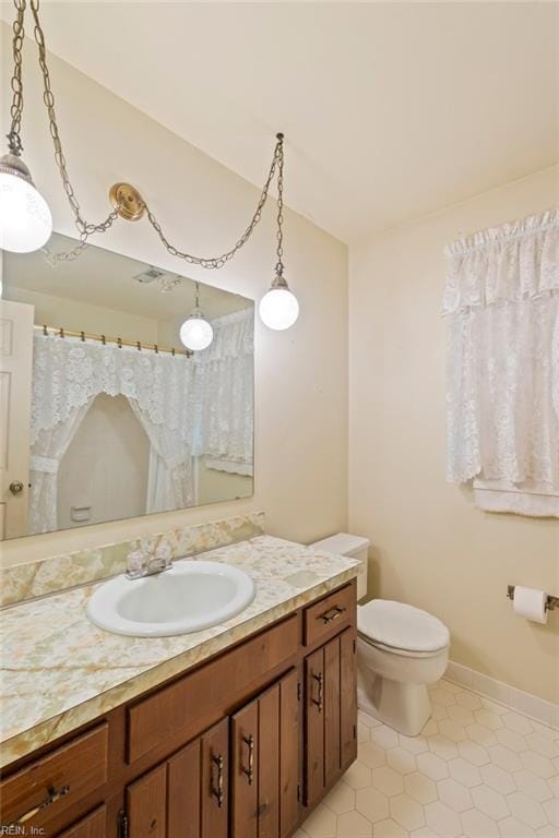 bathroom with vanity and toilet