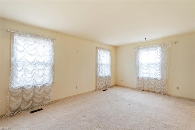 unfurnished room with light colored carpet