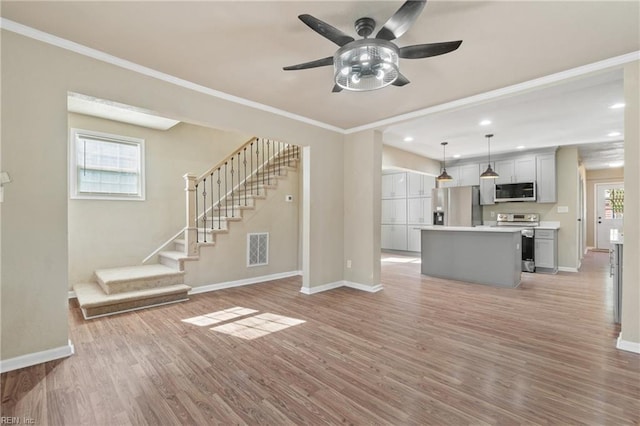 unfurnished living room featuring crown molding, ceiling fan, and light wood-type flooring