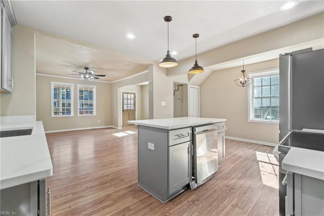 kitchen featuring pendant lighting, gray cabinets, a center island, and appliances with stainless steel finishes