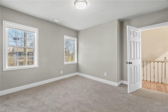 spare room with light colored carpet