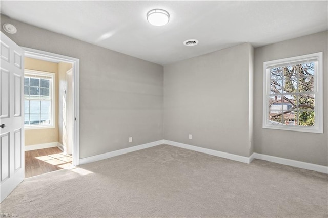 carpeted empty room featuring a healthy amount of sunlight