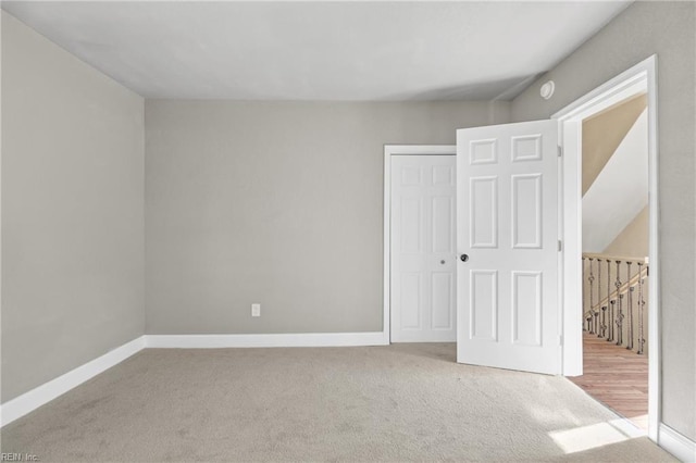 unfurnished bedroom with light carpet and a closet