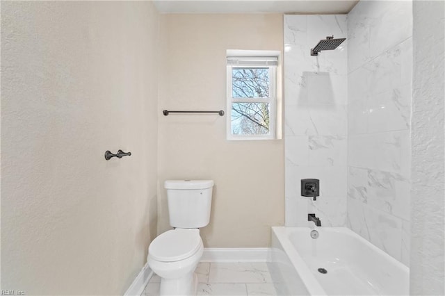 bathroom with tiled shower / bath combo and toilet